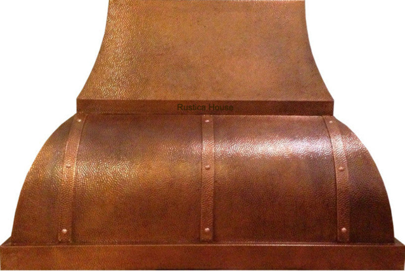 Handcrafted hammered copper range hood with riveted straps and rustic Italian design
