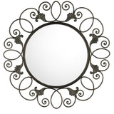 Leaf Crest Wrought Iron Wall Mirror with a round reflective center surrounded by an ornate black iron frame featuring looping scrolls and stylized leaf accents, showcasing elegant handcrafted detailing.