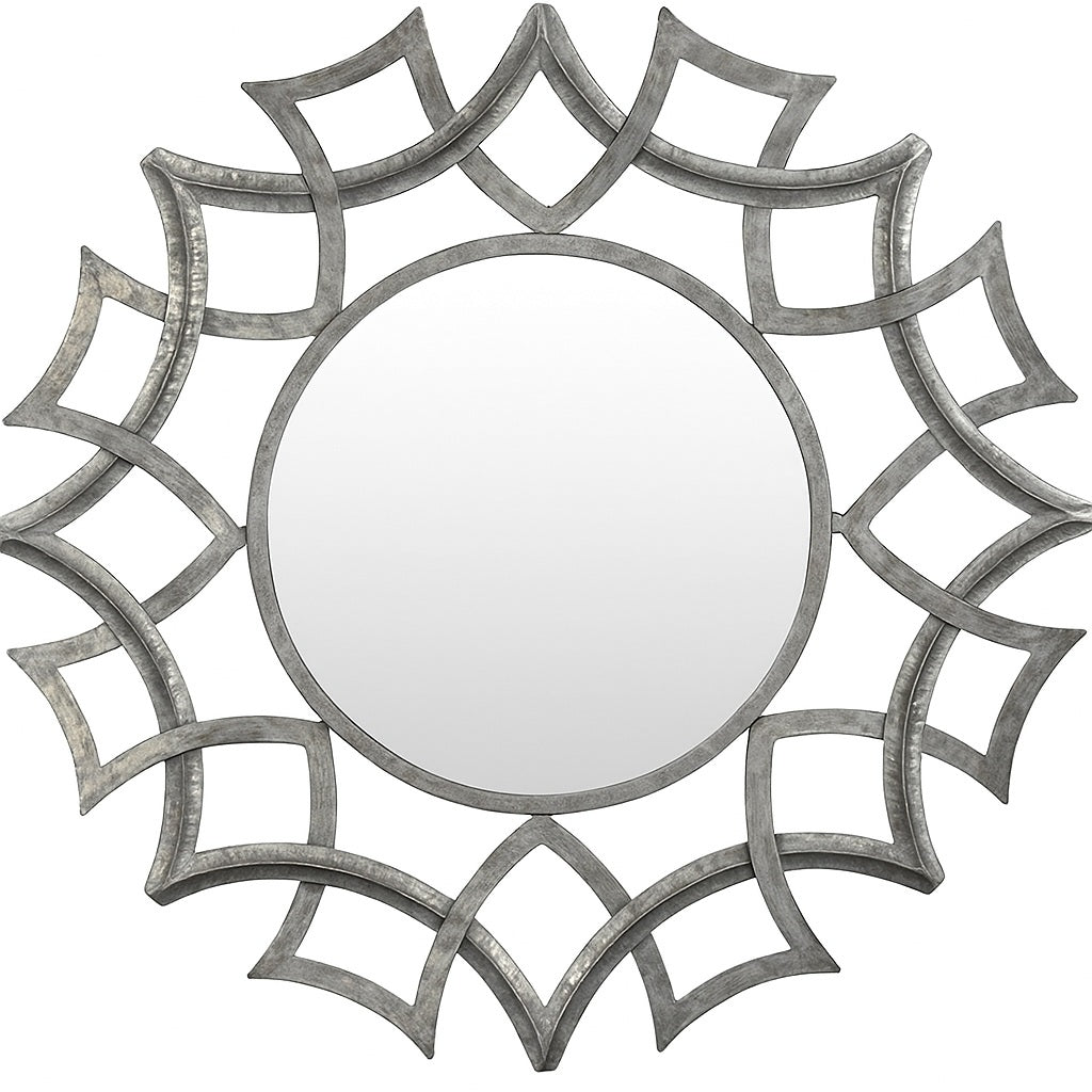 Sunburst Frame Wrought Iron Wall Mirror with a round reflective surface surrounded by an intricate geometric iron frame resembling overlapping sun rays, showcasing a handcrafted metallic finish with artistic symmetry.