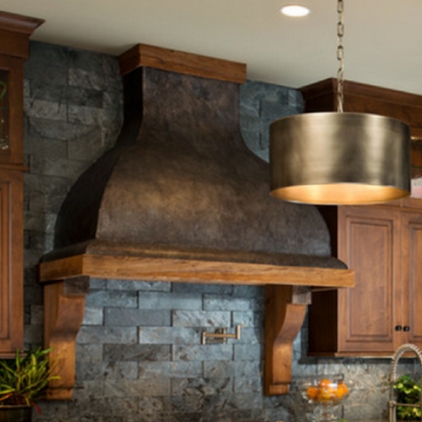 copper range hood with wood trim and corbels