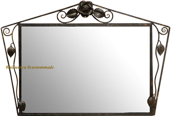 Rose Accent Wrought Iron Wall Mirror with a rectangular reflective surface framed by dark iron scrollwork, featuring a sculpted rose and leaf accents at the top and sides, combining floral artistry with handcrafted metal design.